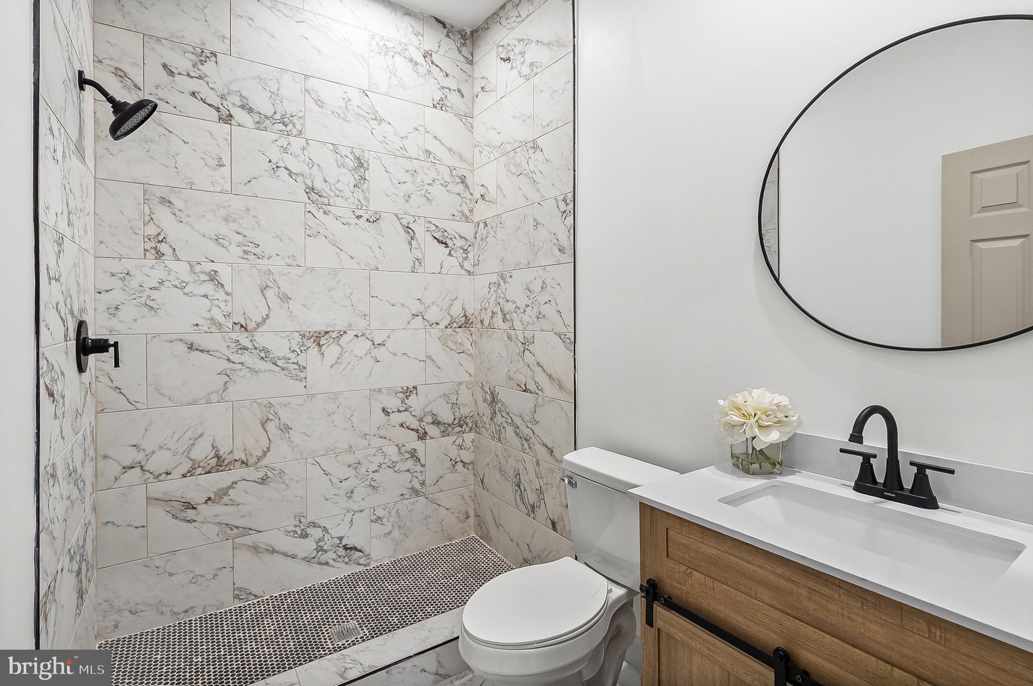 2508 East Preston Street Baltimore, MD 21213 - Photo 21 of 29 a bathroom with a sink toilet and a mirror