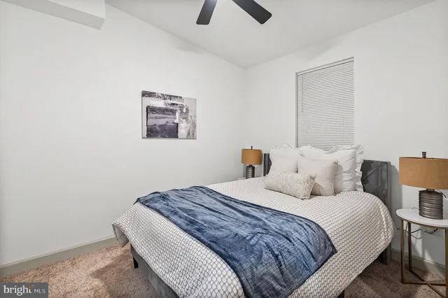 a bedroom with a bed and a painting on the wall