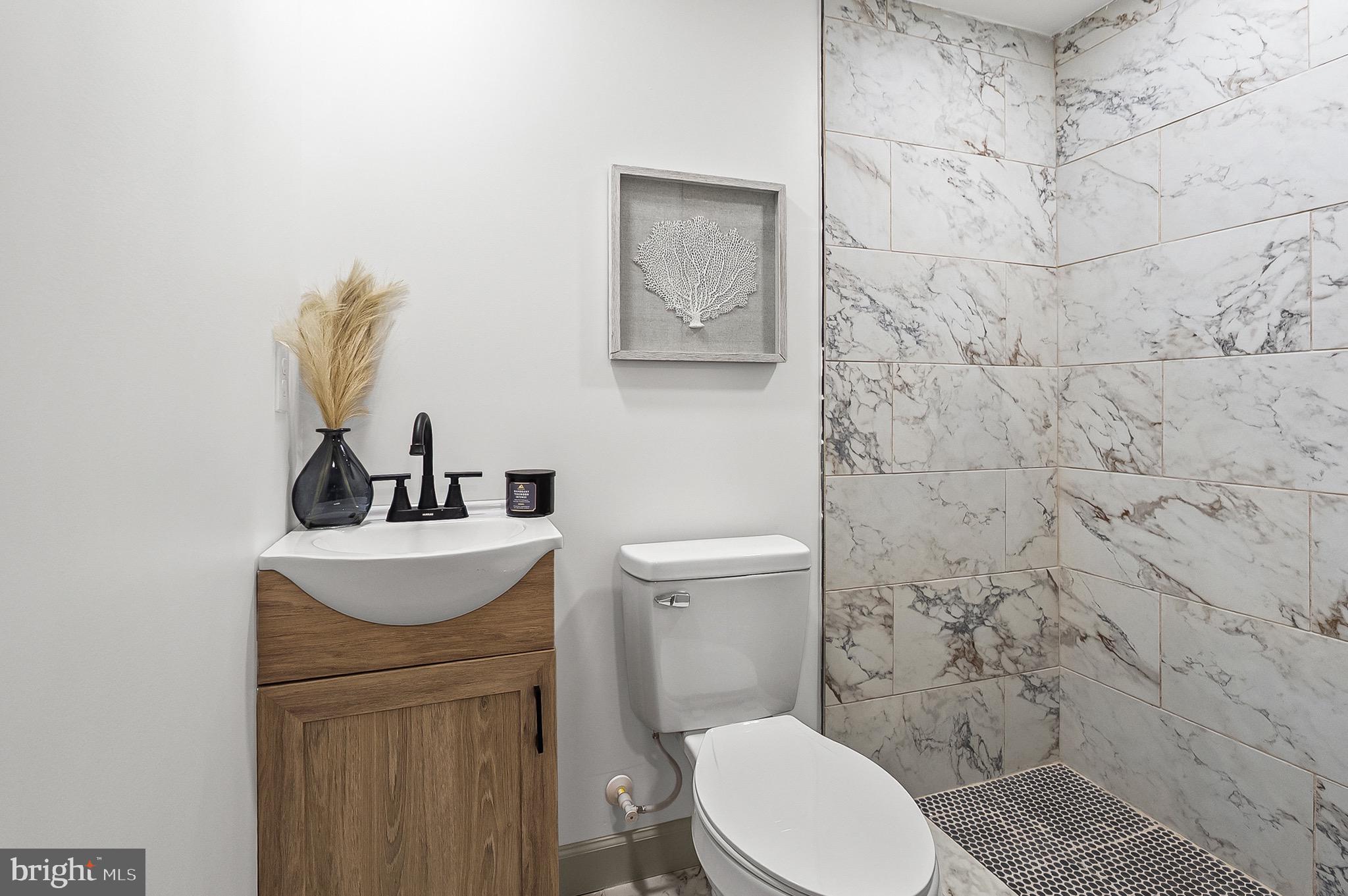 2508 East Preston Street Baltimore, MD 21213 - Photo 26 of 29 a bathroom with a toilet a sink and mirror
