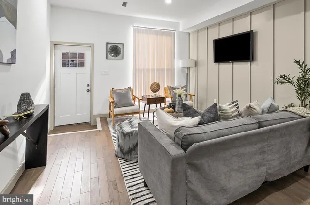 a living room with furniture and a flat screen tv