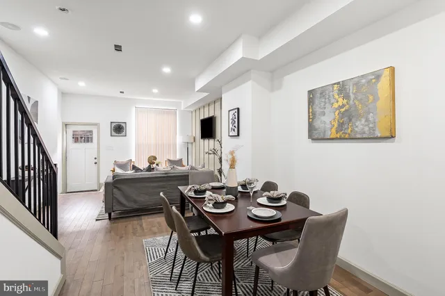 a view of a dining room with furniture and wooden floor