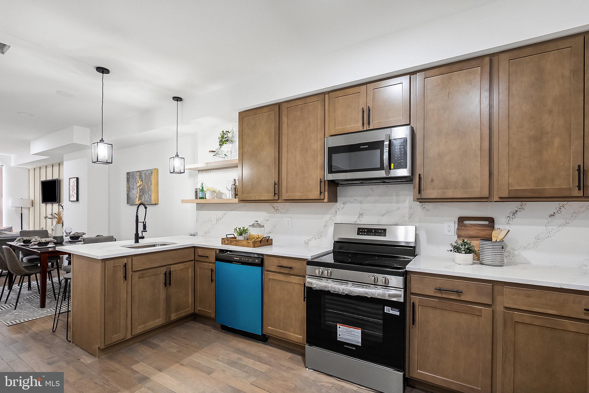 2508 East Preston Street Baltimore, MD 21213 - Photo 7 of 29 a kitchen with stainless steel appliances a stove sink microwave and cabinets