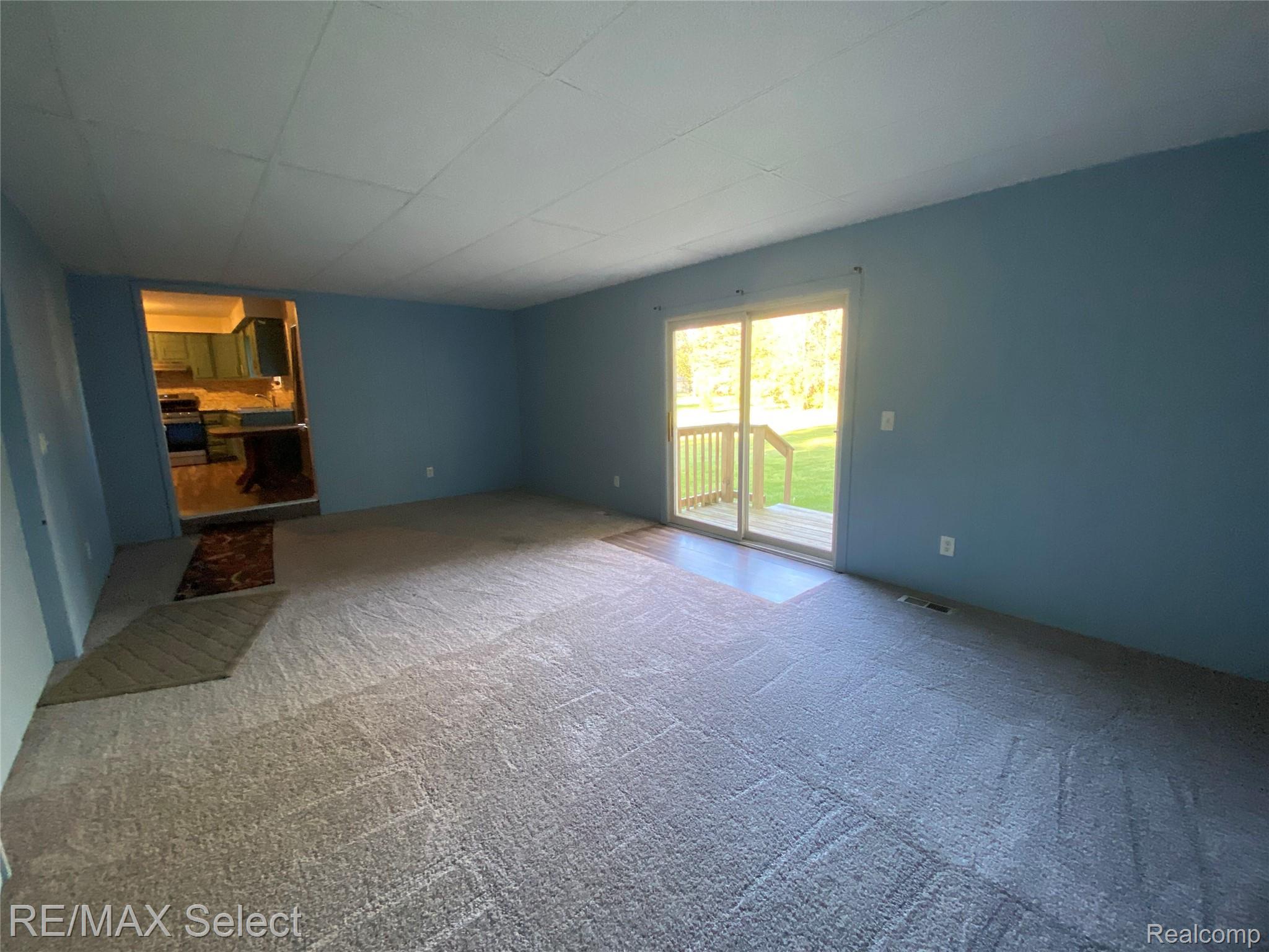 6169 Johnson Road Flushing, MI 48433 - Photo 9 of 28 Unfurnished living room with carpet
