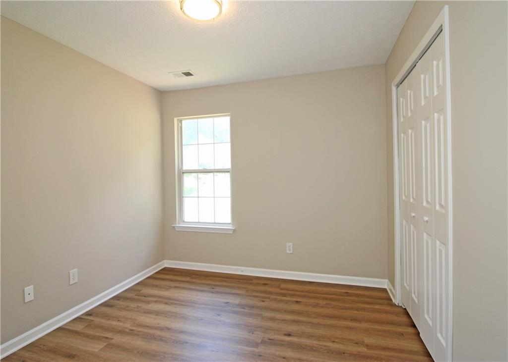1334 Ambercrest Way Austell, GA 30168 - Photo 18 of 20 a view of an empty room with wooden floor and a window