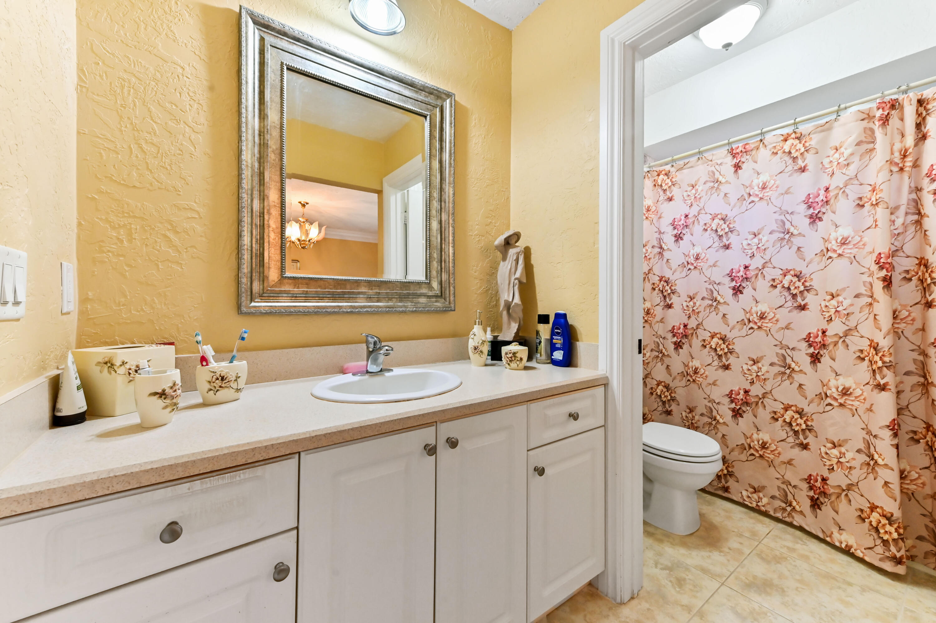 1100 Summer Street, Unit 1 Palm Springs, FL 33461 - Photo 15 of 34 a bathroom with a granite countertop sink mirror and toilet