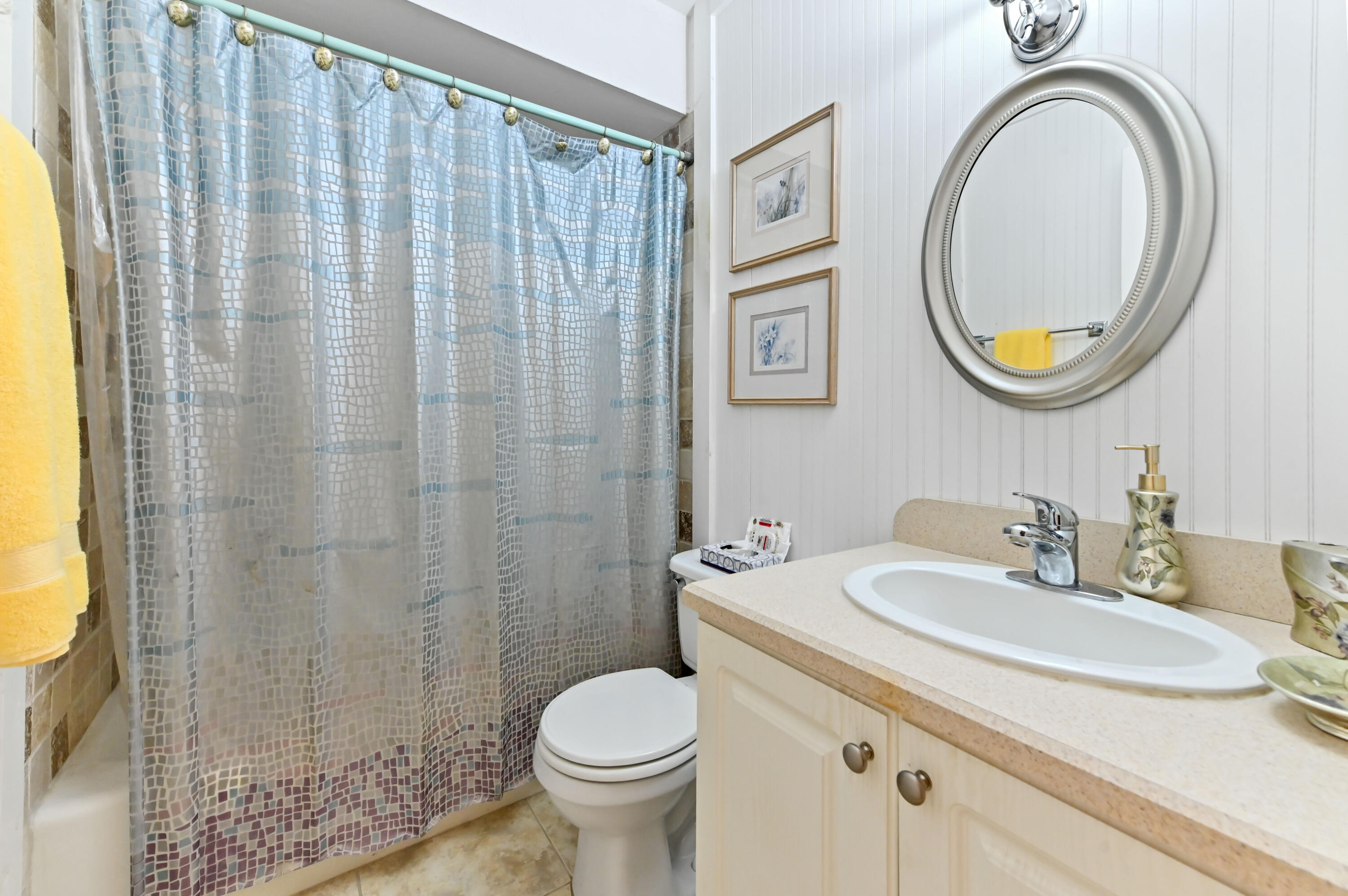 1100 Summer Street, Unit 1 Palm Springs, FL 33461 - Photo 20 of 34 a bathroom with a sink a mirror a toilet and a shower