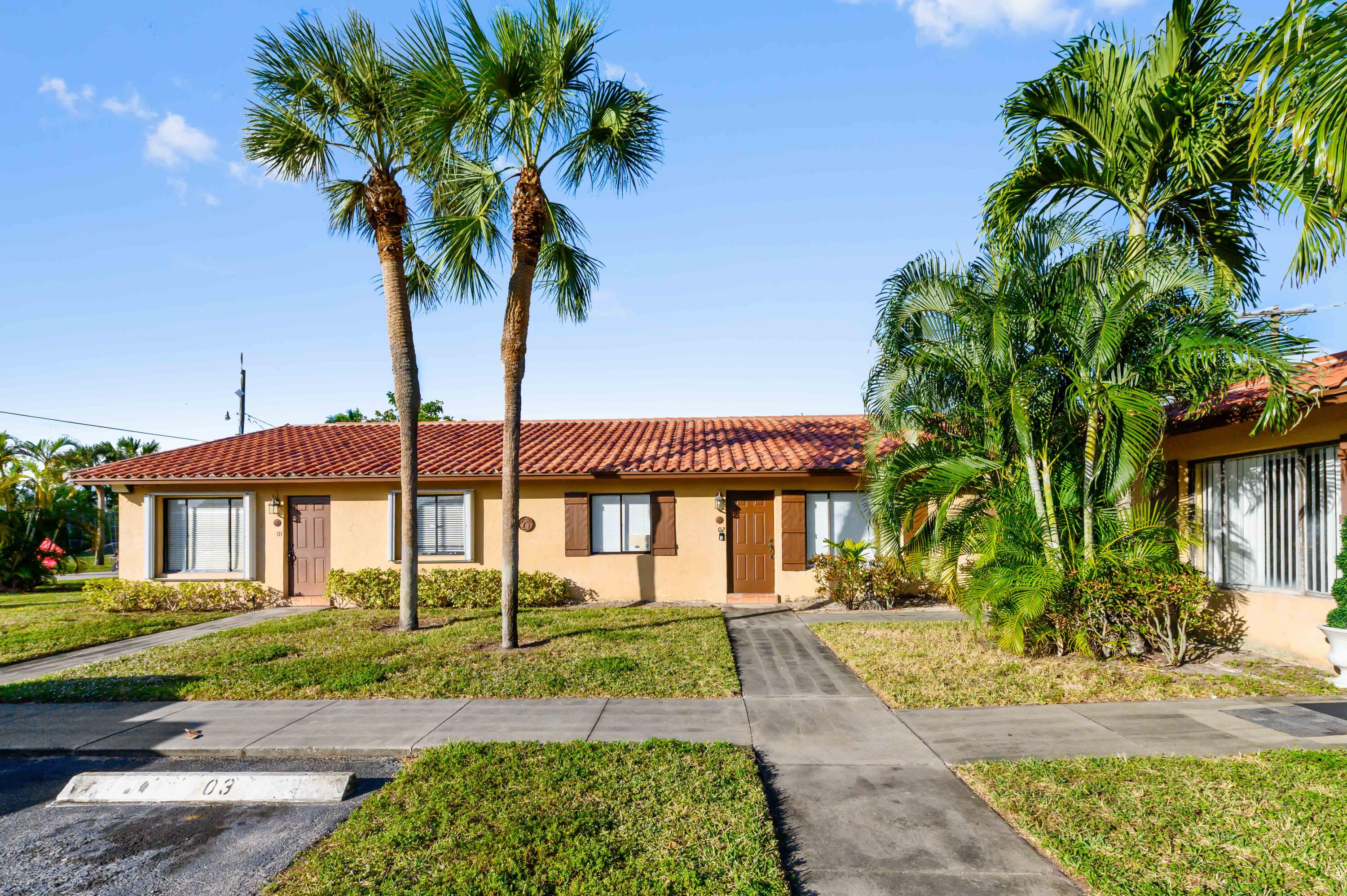 1100 Summer Street, Unit 1 Palm Springs, FL 33461 - Photo 21 of 34 a front view of a house with a garden