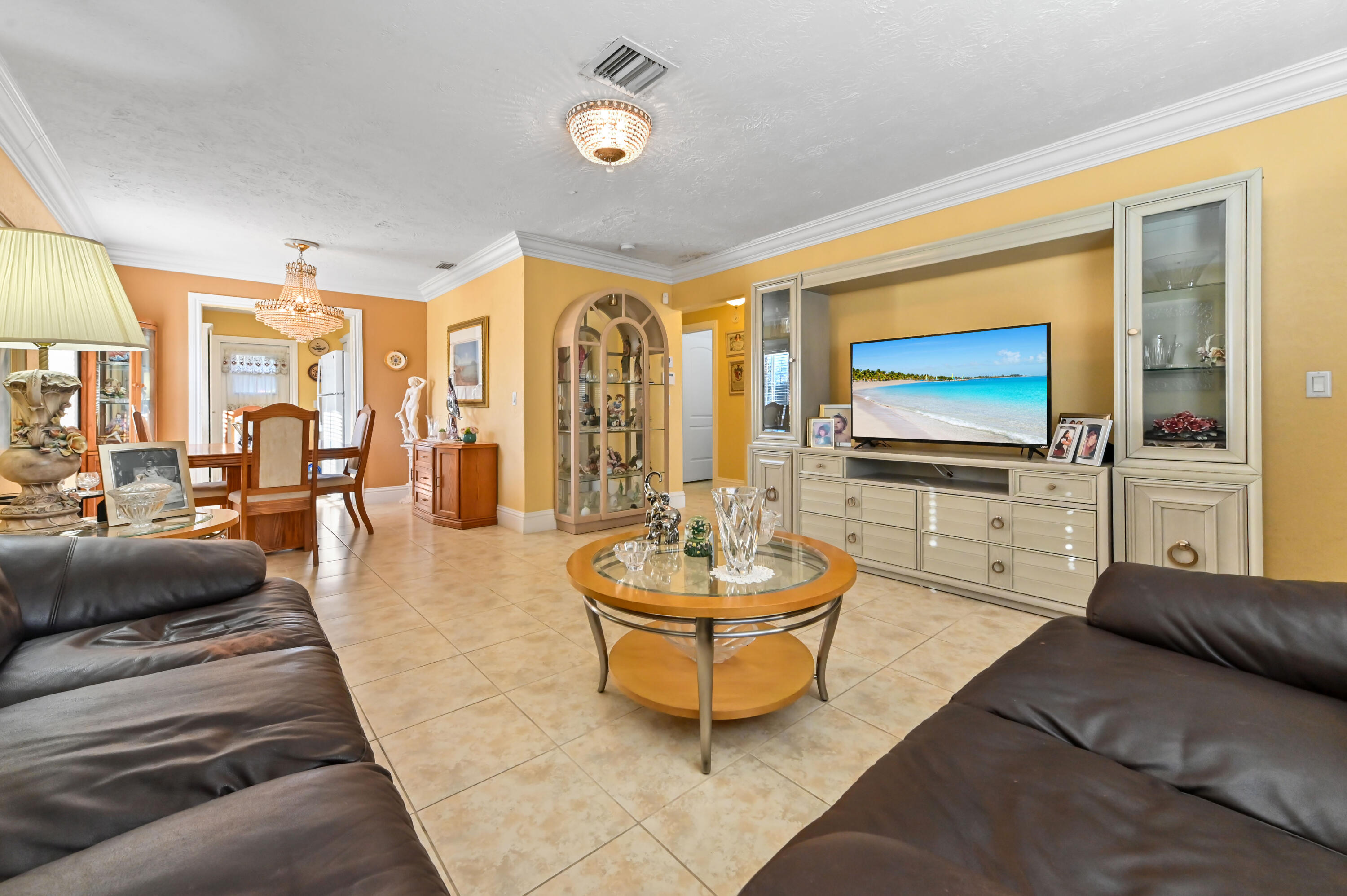 1100 Summer Street, Unit 1 Palm Springs, FL 33461 - Photo 3 of 34 a living room with furniture and a flat screen tv
