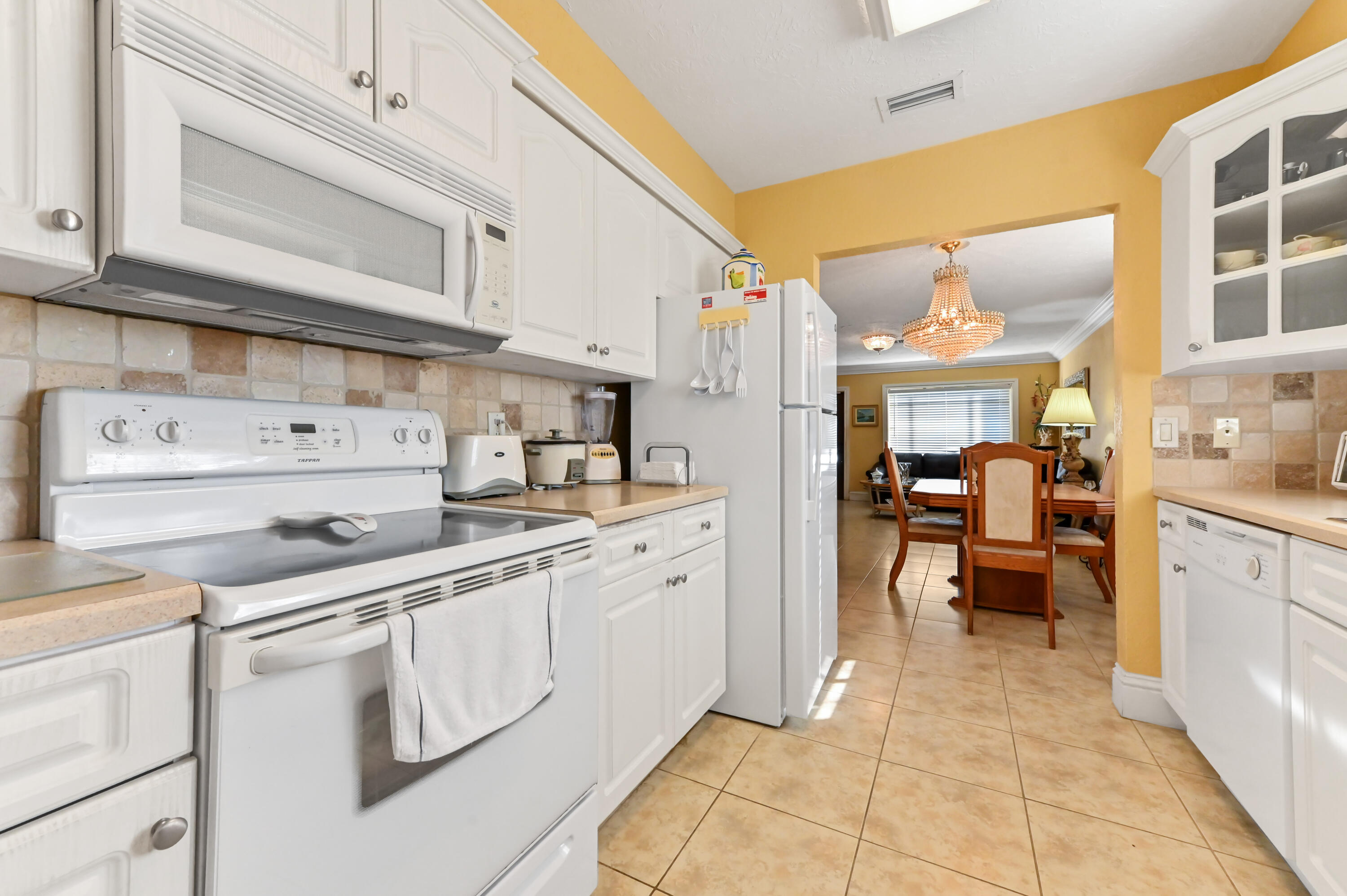 1100 Summer Street, Unit 1 Palm Springs, FL 33461 - Photo 6 of 34 a kitchen with stainless steel appliances granite countertop a sink and cabinets
