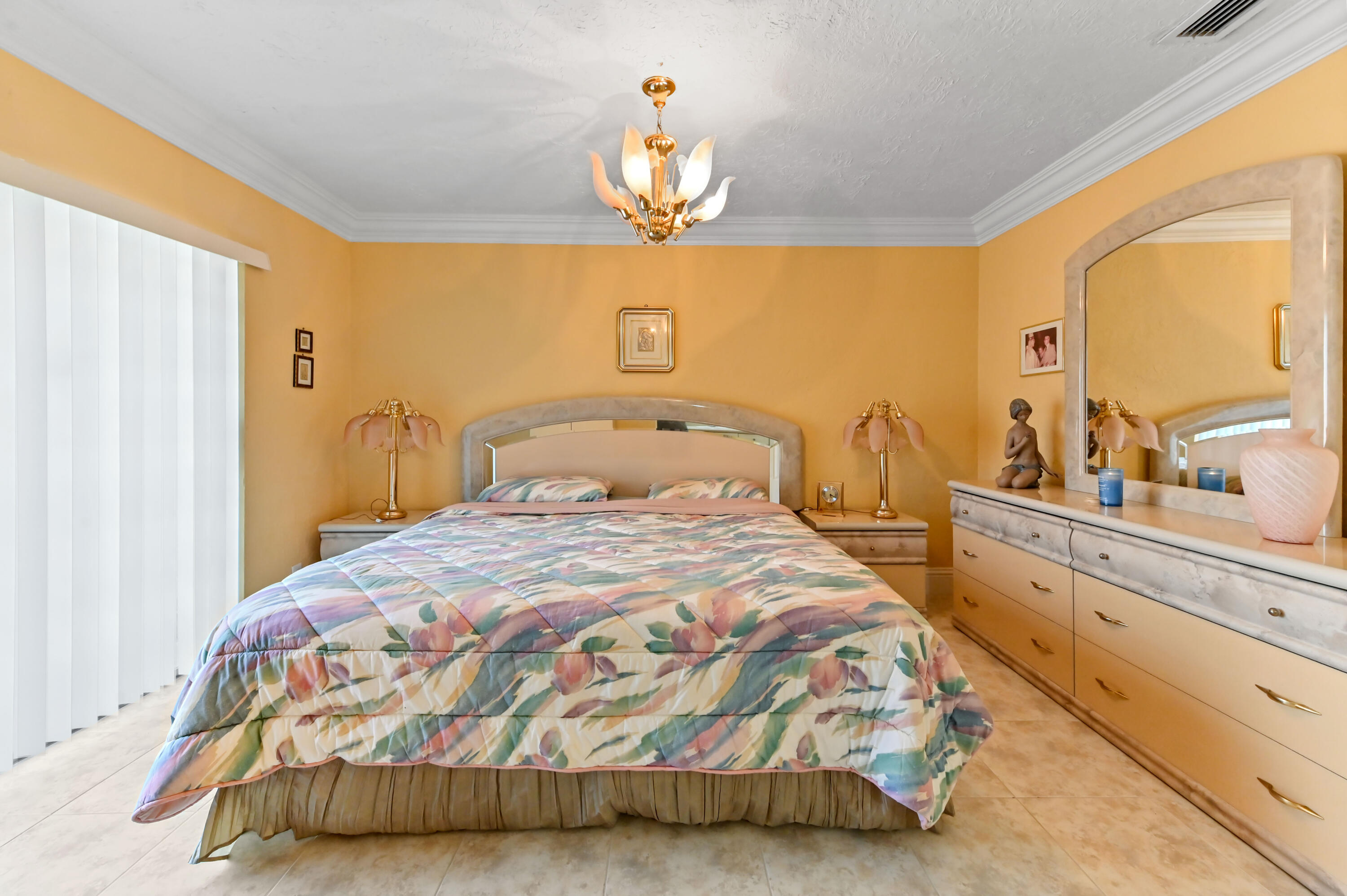 1100 Summer Street, Unit 1 Palm Springs, FL 33461 - Photo 7 of 34 a bedroom with a bed and a chandelier