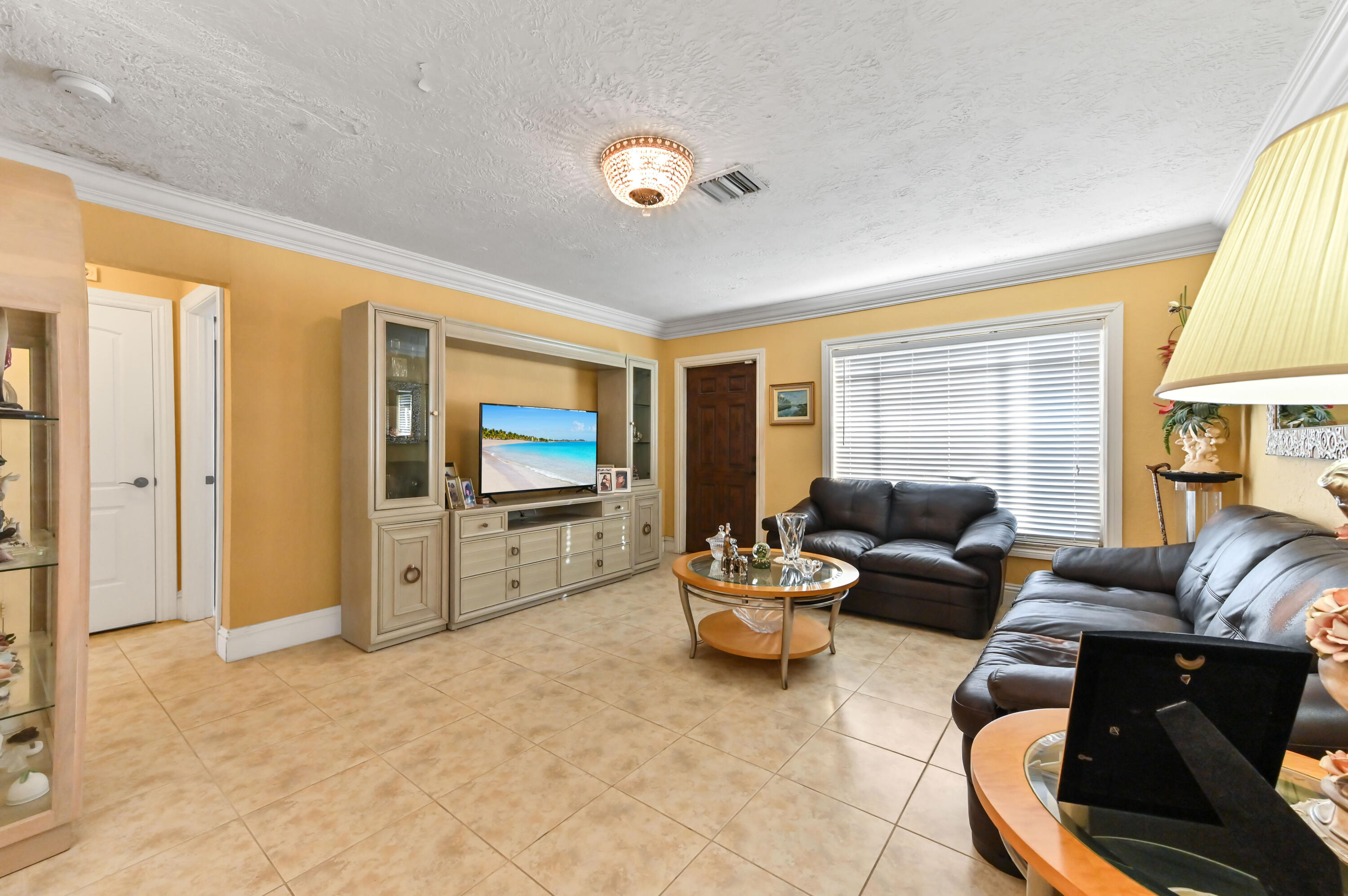 1100 Summer Street, Unit 1 Palm Springs, FL 33461 - Photo 10 of 34 a living room with furniture and a flat screen tv
