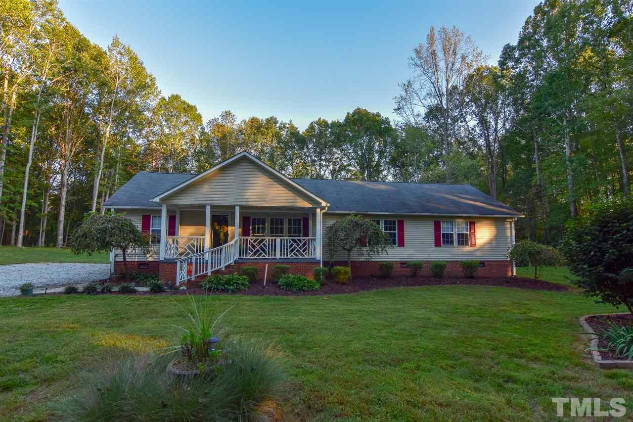 727 Ned Moore Road Timberlake, NC 27583 - Photo 1 of 24 a front view of a house with garden