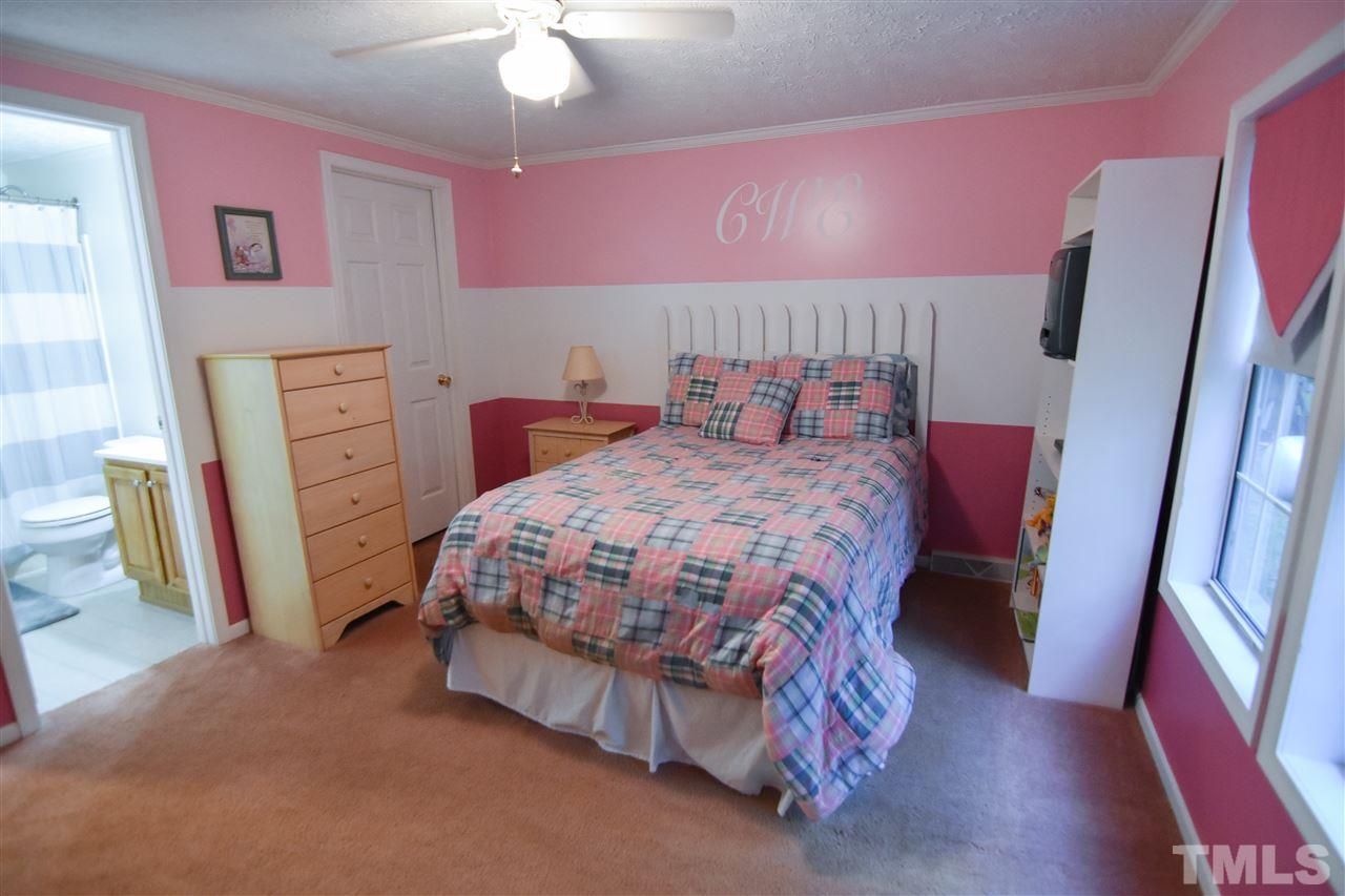 727 Ned Moore Road Timberlake, NC 27583 - Photo 18 of 24 a bedroom with a bed and a mirror on dresser