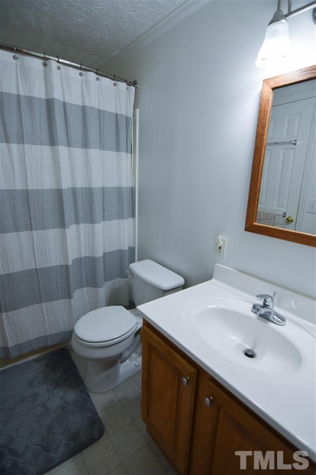 727 Ned Moore Road Timberlake, NC 27583 - Photo 19 of 24 a bathroom with a sink and a mirror