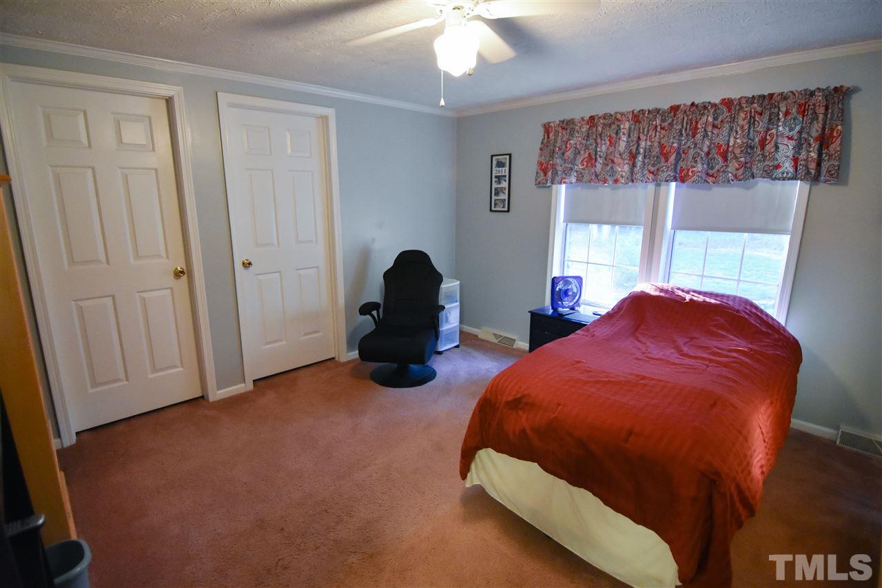 727 Ned Moore Road Timberlake, NC 27583 - Photo 20 of 24 a bed room with a bed and a window