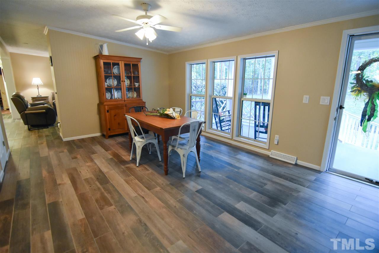 727 Ned Moore Road Timberlake, NC 27583 - Photo 3 of 24 a view of a dining room with furniture and wooden floor