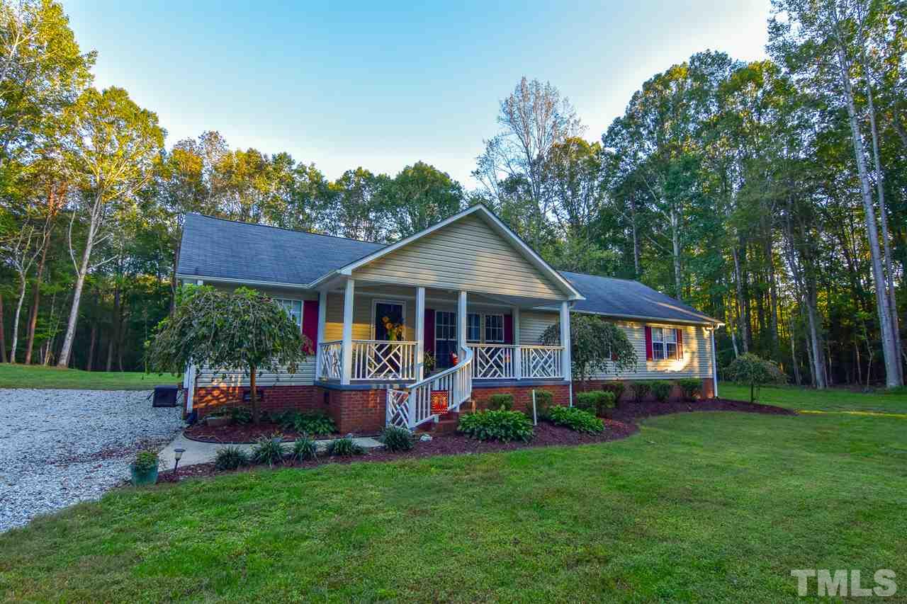 727 Ned Moore Road Timberlake, NC 27583 - Photo 24 of 24 a front view of a house with a yard and green space