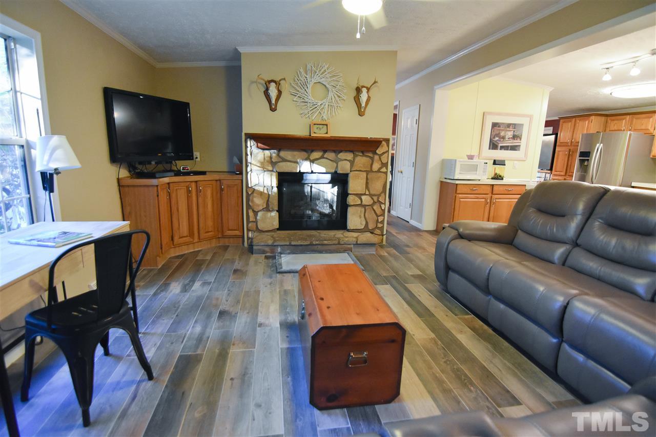 727 Ned Moore Road Timberlake, NC 27583 - Photo 7 of 24 a living room with furniture and a flat screen tv