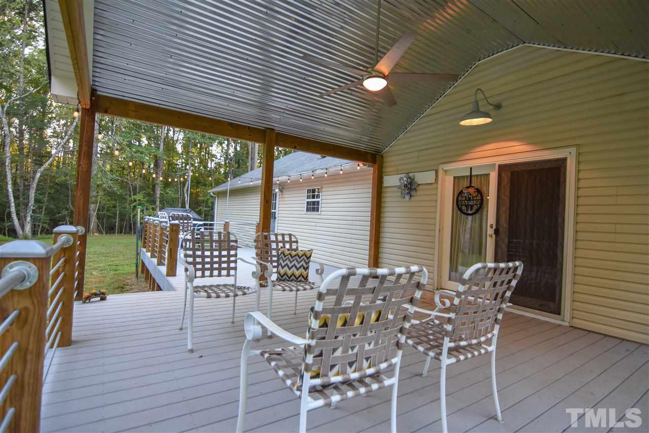 727 Ned Moore Road Timberlake, NC 27583 - Photo 9 of 24 a patio with wooden floor and outdoor seating