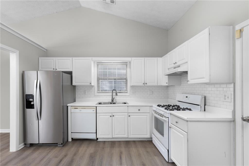 2110 Racquet Club Circle Northwest Lawrenceville, GA 30043 - Photo 13 of 44 a kitchen with white cabinets sink and white appliances