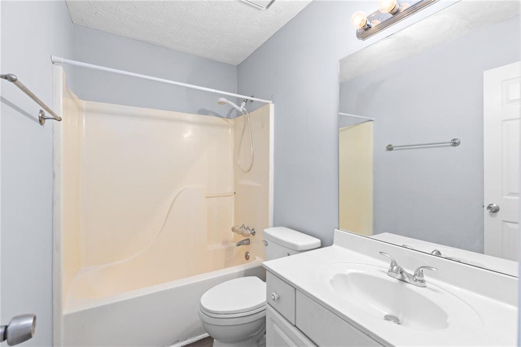 2110 Racquet Club Circle Northwest Lawrenceville, GA 30043 - Photo 15 of 44 a bathroom with a sink toilet and shower