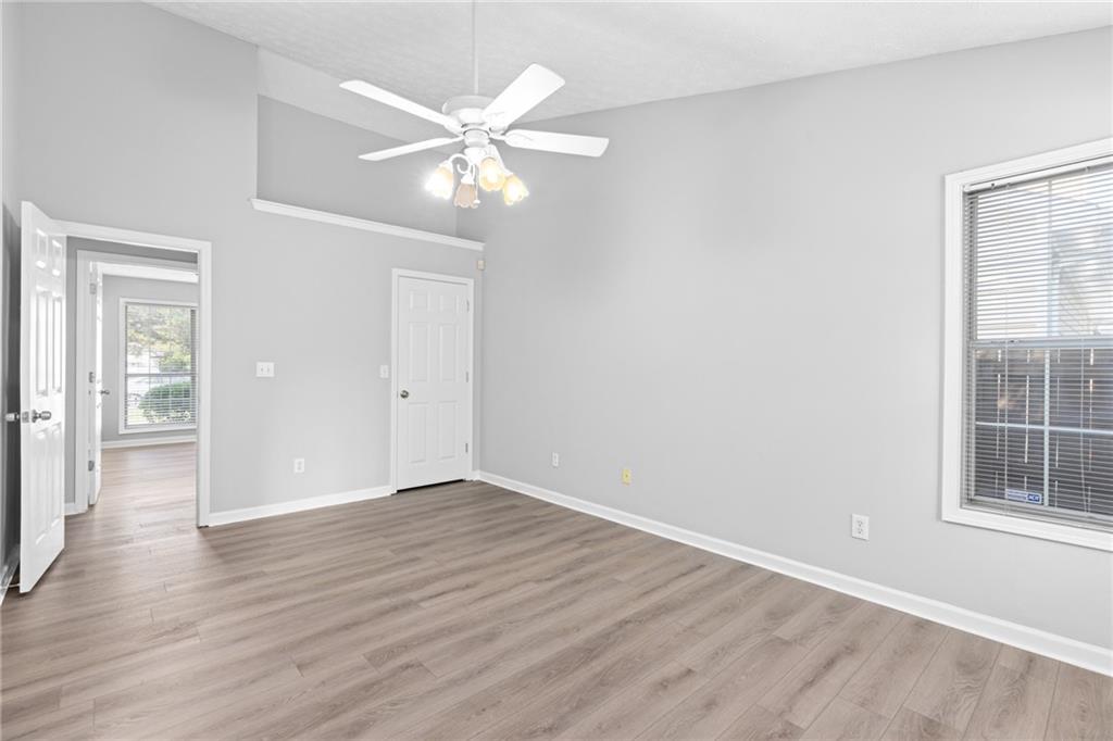 2110 Racquet Club Circle Northwest Lawrenceville, GA 30043 - Photo 22 of 44 a view of an empty room with wooden floor and a window