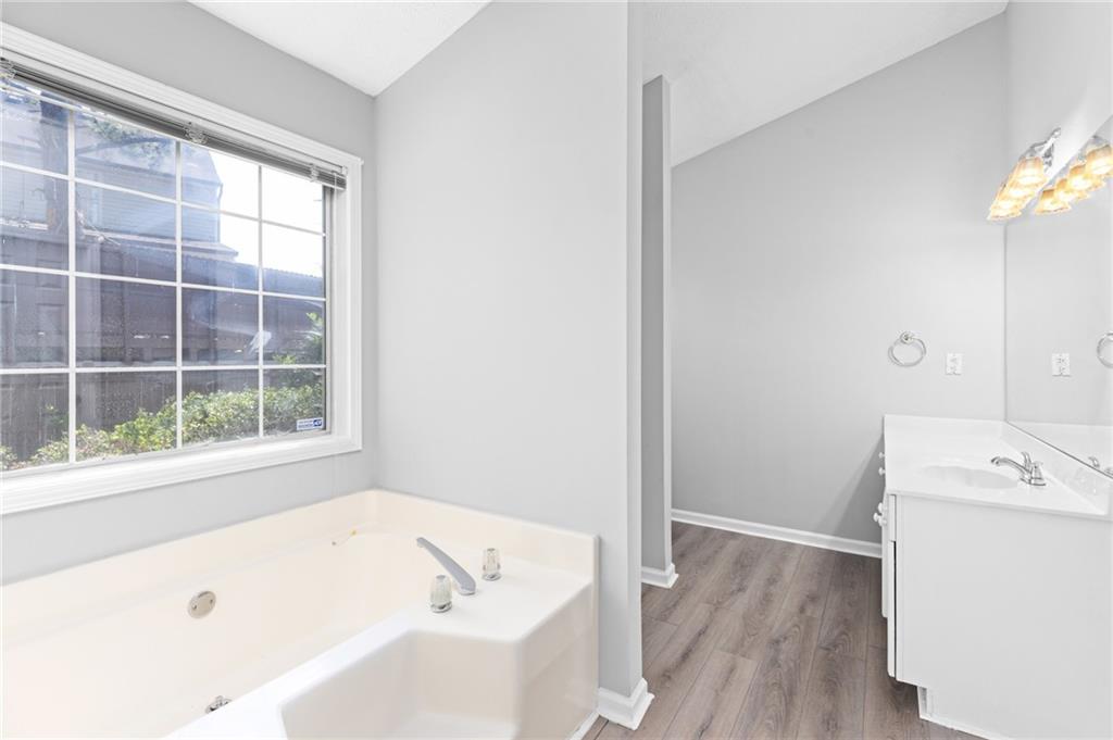2110 Racquet Club Circle Northwest Lawrenceville, GA 30043 - Photo 24 of 44 a bathroom with a tub a sink and a window