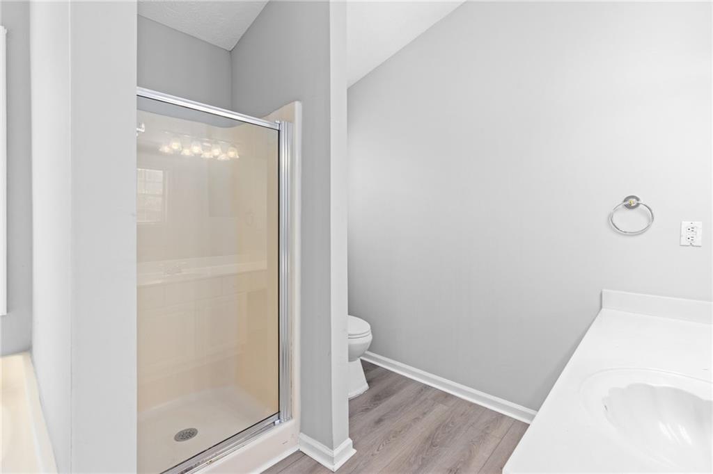 2110 Racquet Club Circle Northwest Lawrenceville, GA 30043 - Photo 25 of 44 a bathroom with a glass shower door