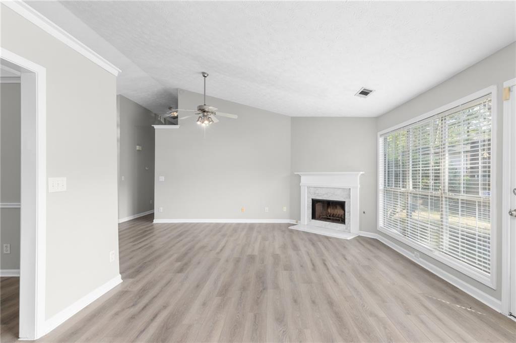 2110 Racquet Club Circle Northwest Lawrenceville, GA 30043 - Photo 4 of 44 a view of a livingroom with wooden floor fireplace and window