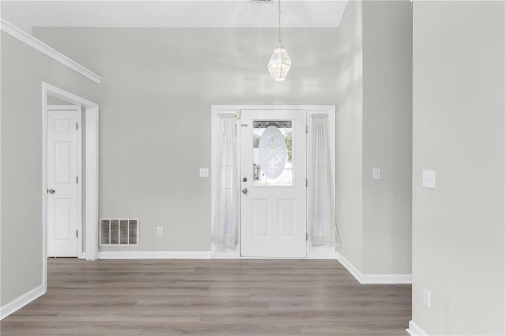 2110 Racquet Club Circle Northwest Lawrenceville, GA 30043 - Photo 5 of 44 a view of a hallway with wooden floor