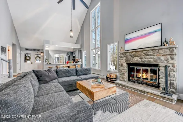 a living room with furniture and wooden floor