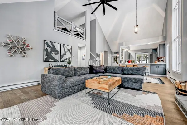 a kitchen with stainless steel appliances kitchen island granite countertop a dining table chairs and a refrigerator