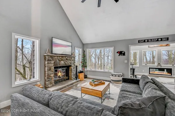 a view of a dining room with furniture and a chandelier