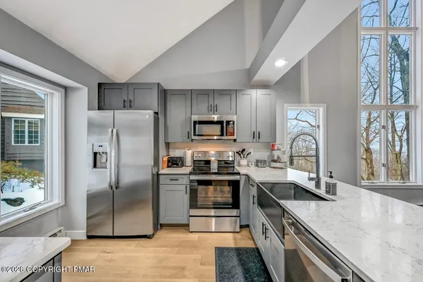 a bedroom with a bed and a large window