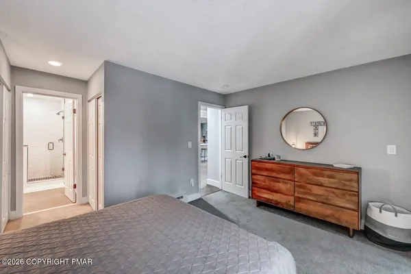 a living room with furniture gym equipment and a rug