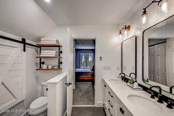 a bedroom with a bed and a chair