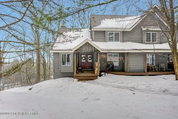 a front view of a house with a yard in front of it