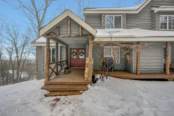 a front view of a house with a yard and seating space