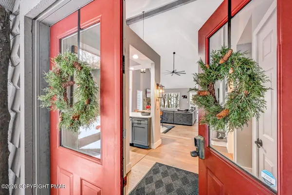 a living room with furniture large window and a fireplace