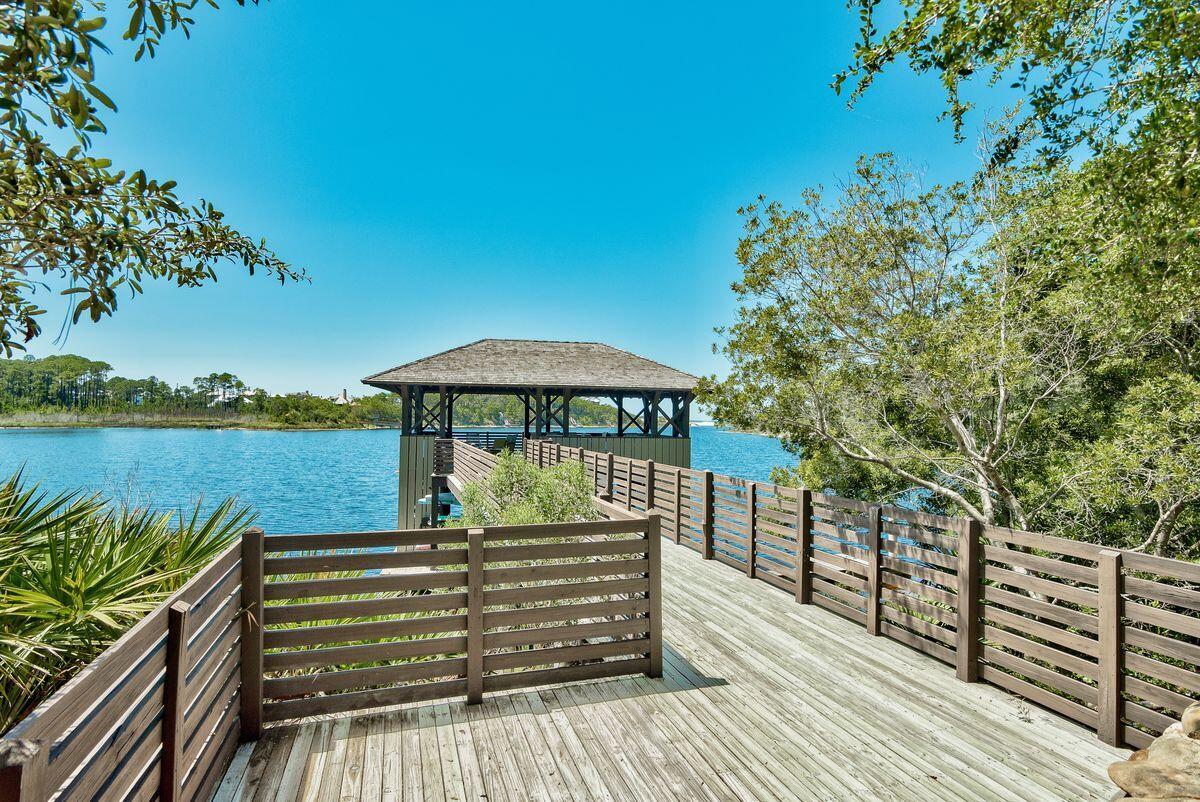 8-9 Sinclair Lane Santa Rosa Beach, FL 32459 - Photo 10 of 21 a view of a deck with chairs and wooden floor