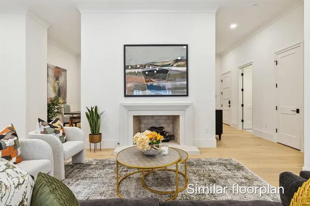 a living room with furniture a fireplace and wall paintings
