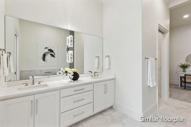a en suite bathroom with double sink and a mirror