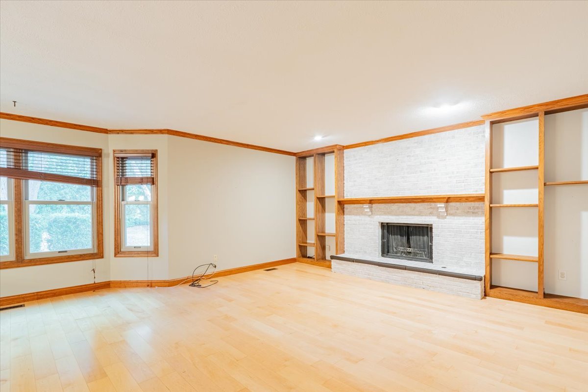 10 Inverness Drive Bloomington, IL 61701 - Photo 17 of 43 an empty room with fireplace and a window