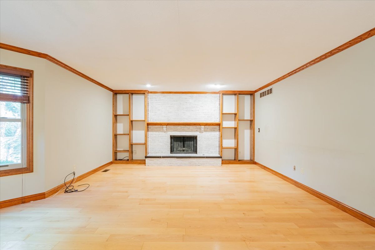 10 Inverness Drive Bloomington, IL 61701 - Photo 18 of 43 a view of an empty room with a fireplace and a window