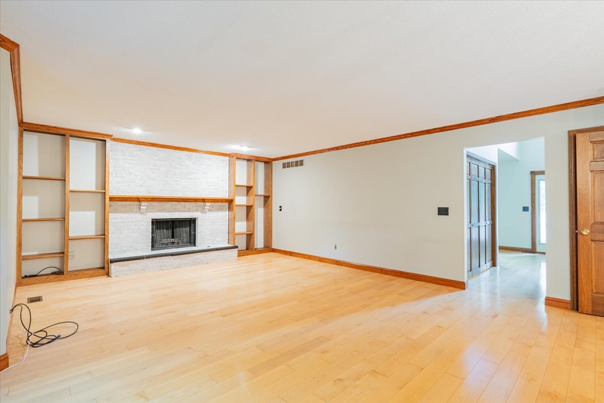 10 Inverness Drive Bloomington, IL 61701 - Photo 19 of 43 a view of an empty room with a fireplace and a window