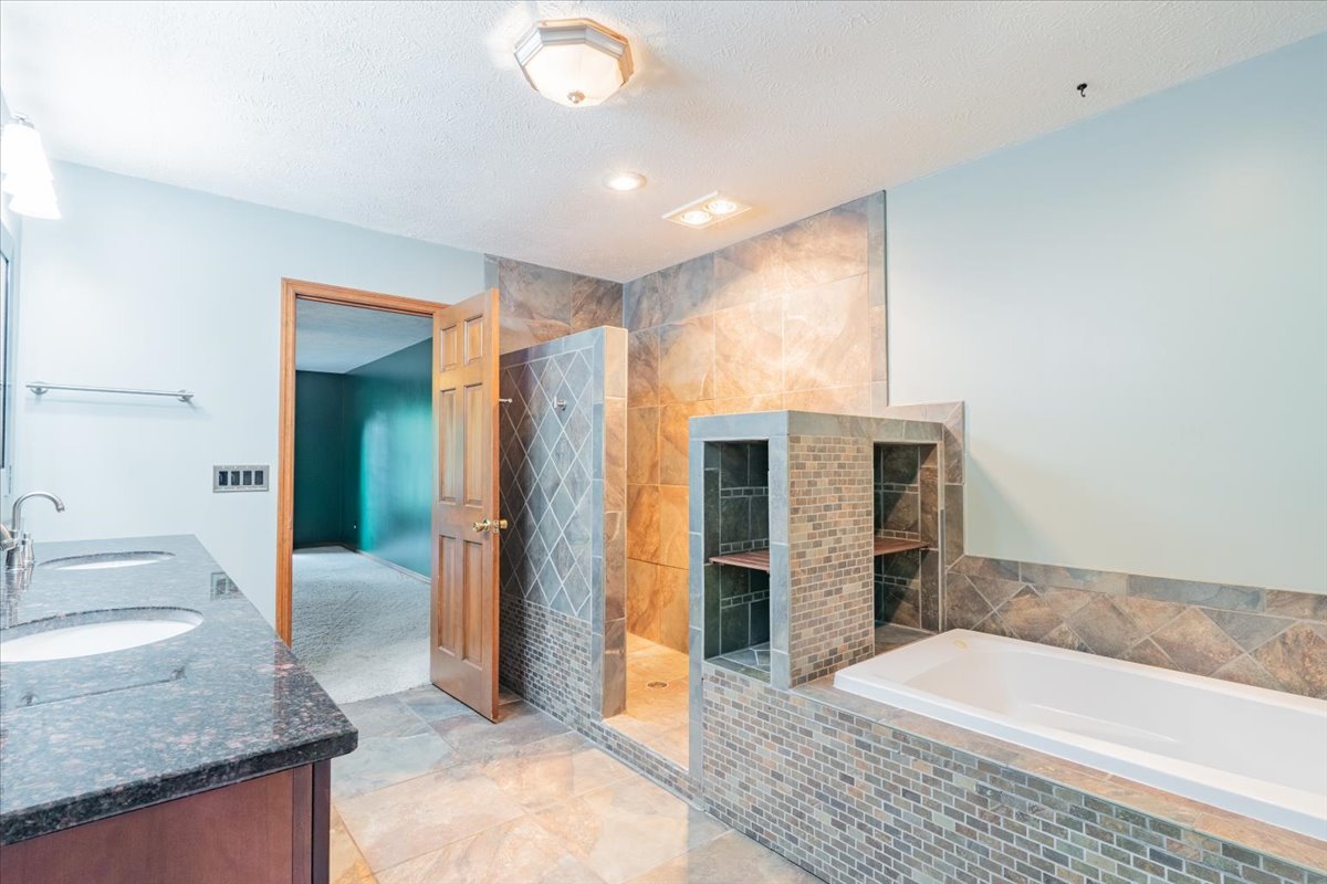 10 Inverness Drive Bloomington, IL 61701 - Photo 24 of 43 a bathroom with a granite countertop sink and mirror