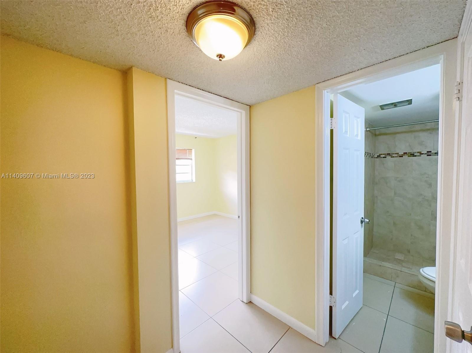 22615 Southwest 66th Avenue, Unit 216 Boca Raton, FL 33428 - Photo 11 of 23 a view of a bathroom from a hallway
