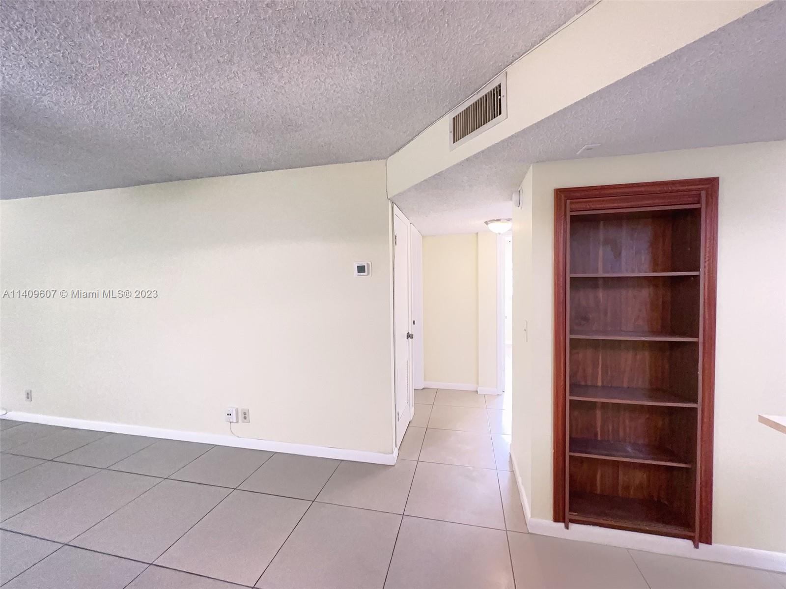 22615 Southwest 66th Avenue, Unit 216 Boca Raton, FL 33428 - Photo 12 of 23 a view of walk in closet with empty racks