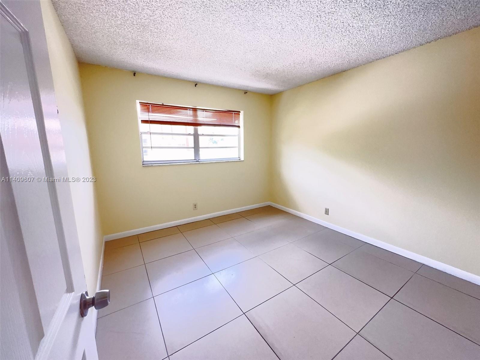 22615 Southwest 66th Avenue, Unit 216 Boca Raton, FL 33428 - Photo 14 of 23 an empty room with a window