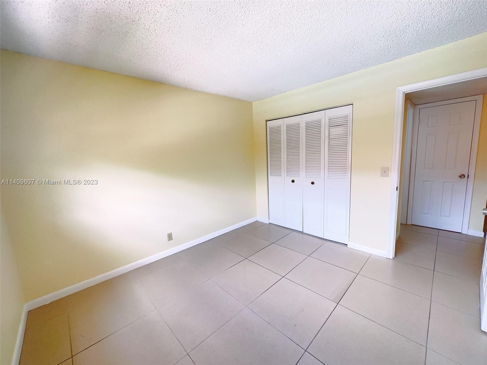 22615 Southwest 66th Avenue, Unit 216 Boca Raton, FL 33428 - Photo 15 of 23 an empty room with an entryway